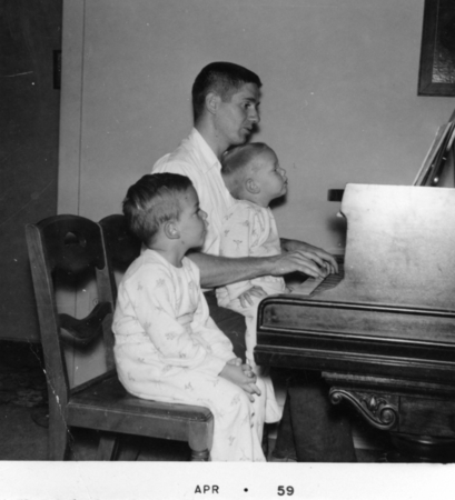 Charles D. Keeling with two of his sons, Eric and Paul, singing songs before bedtime