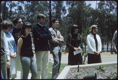 Students watch as a commemorative tree is planted by the class of 1968