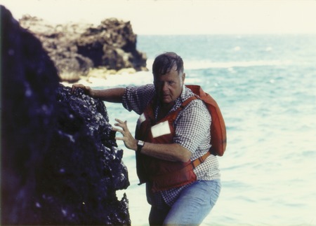 Harmon Craig sampling the basaltic lavas on one of the La Perouse Pinnacles, after jumping off a boat onto a pinnacle. The...