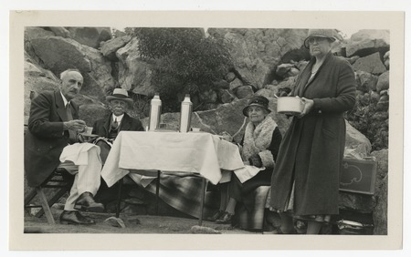 Fred M. White, George Marston, Mary Yawkey White and Mary Fletcher picnicking among boulders