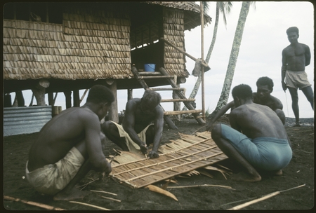 Group of men weaving