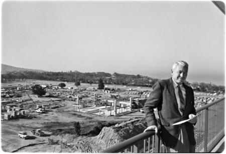 Chancellor John S. Galbraith on Urey Hall balcony with Revelle Commons, under construction, in background