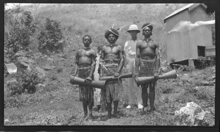 Men wearing barkcloth (tapa) clothing and holding kundu drums, probably in Mambare region, Oro (Northern) Province