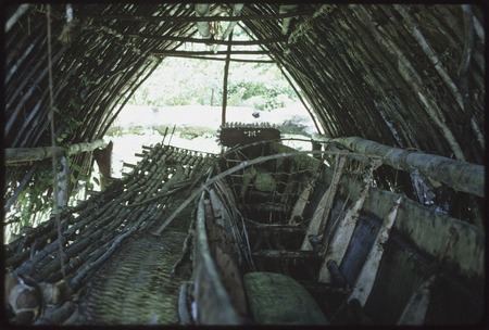 Canoes: detail of kula canoe with prow ornament lined with cowries, under a boathouse shelter
