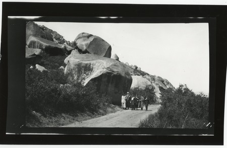 Group on dirt road near granite boulders