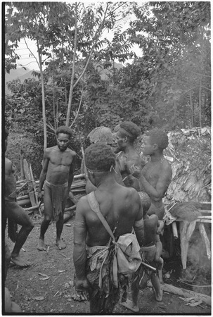 Dispute in Tuguma: men discuss garden damage done by a neighobring group&#39;s pig