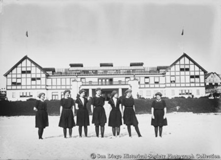Group of women in bathing suits posing on beach at Stratford Inn, Del Mar