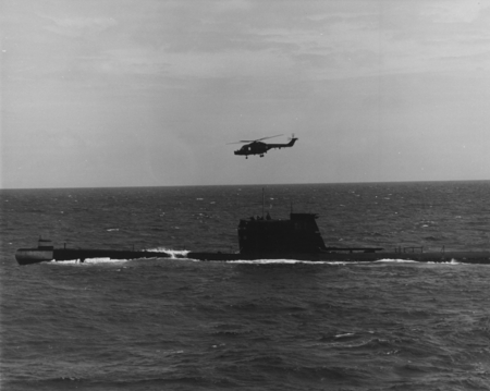 Helicopter hovering over a Russian submarine which surfaced near the D/V Glomar Challenger (ship) during the Deep Sea Dril...