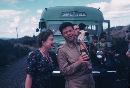 Carl L. Hubbs with unidentified woman, people and bus in background, New Zealand