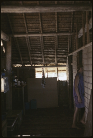 Anne Scheffler standing in doorway inside dwelling