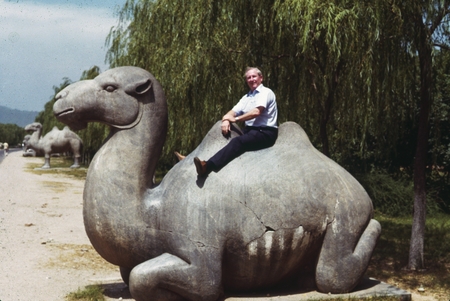 [Henry William Menard sitting on a stone camel]