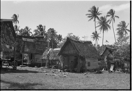 Tukwaukwa village, Kiriwina: houses, people socializing on veranda