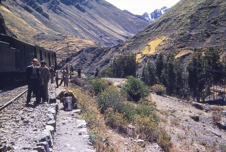 Scientists beside train in the Andes Mountains
