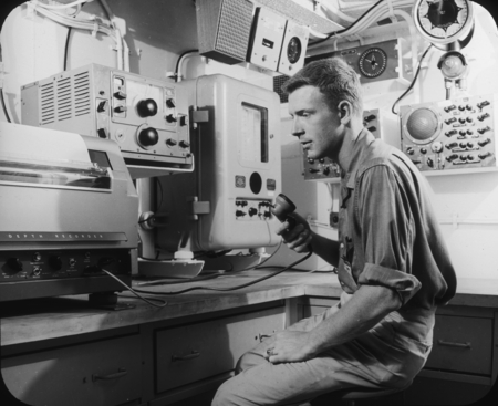 Man with shipboard depth recorder