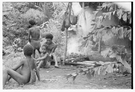 Men and boys standing outside the taualea, feasting shelter, after the ritual.
