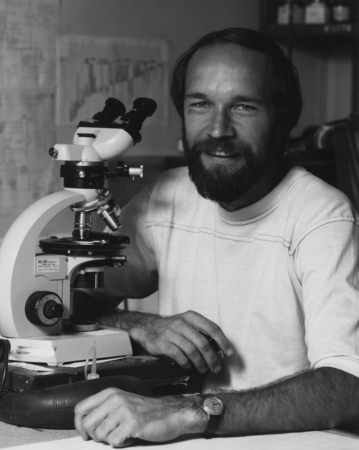Micro-paleontologist Mark Filewicz in front of this microscope during Leg 84 of the Deep Sea Drilling Project. 1982.