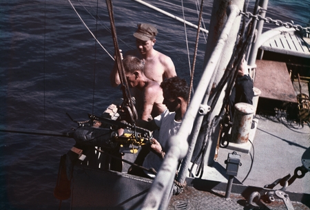 Jeffery Frautschy (center) and two unidentified men shown here were deploying a bathythermograph instrument into the Pacif...