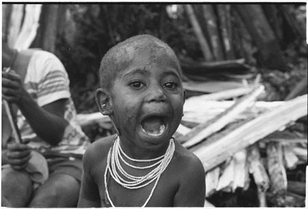 Pig festival, pig sacrifice, Tsembaga: young child with necklace and ear piercing