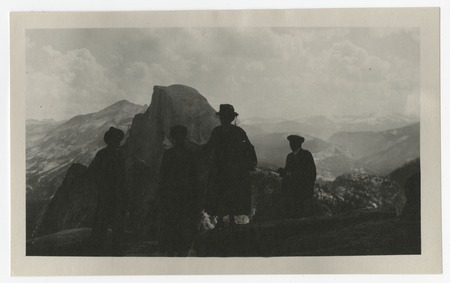 View of Half Dome from Glacier Point with silhouetted figures