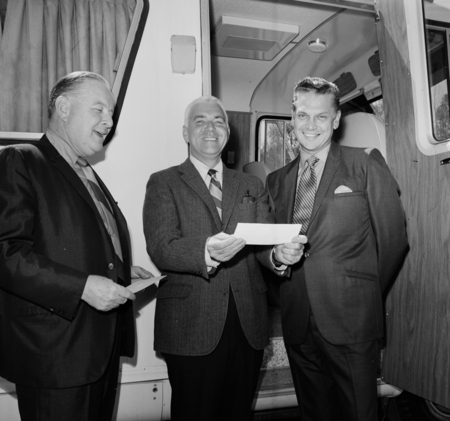 Sears Roebuck Company representatives awarding UC San Diego Chancellor William J. McGill (center) a check to pay for a new...
