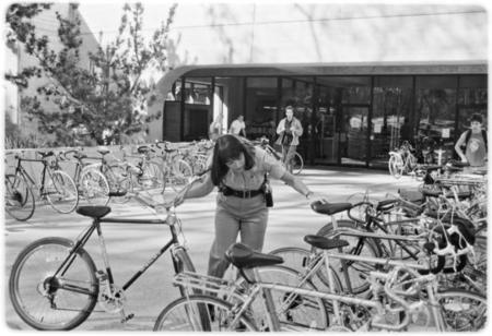 Campus police officer checking bicycles in front of Geisel Library