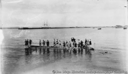 Swimmers on diving platform, Santa Fe Wharf in background