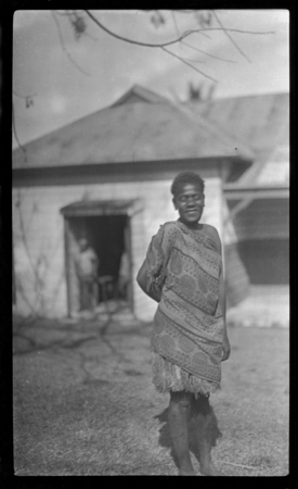 Woman in grass skirt, and cloth wrap