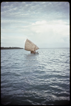Canoe with woven pandanus sail unfurled