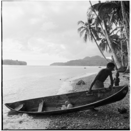 Man pulling canoe ashore