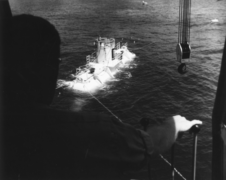Crane Operator on the Staging Vessel waits for SeaLab II to be towed into position for lowering