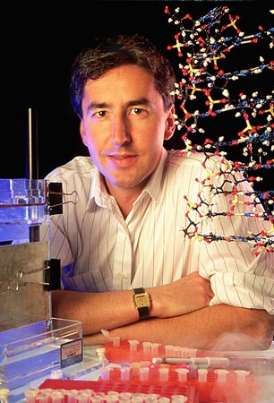 Gerald Joyce with DNA model and laboratory equipment