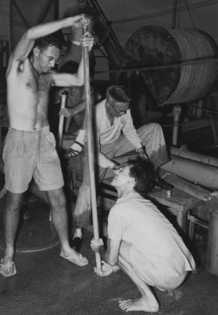 Robert L. Fisher, Milton Nunn Bramlette, and William Riedel (left to right) with a core sample aboard R/V Spencer F. Baird