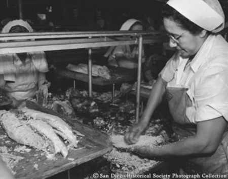 Woman cleaning fish at Sun Harbor Packing Corporation