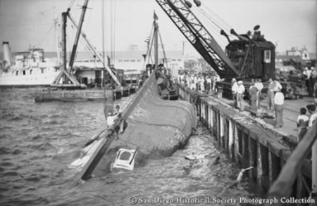 Crane raising sunken tuna boat Vantuna at San Diego pier