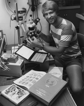 Scientist Scott Jean Hills from Scripps Institution of Oceanography working at a microscope in the Core Lab, aboard the D/...