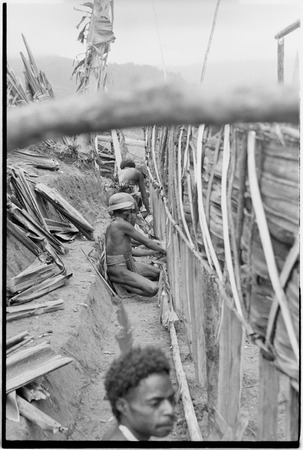 House-building for Rappaports: siding made of pandanus leaves being added to wall frame