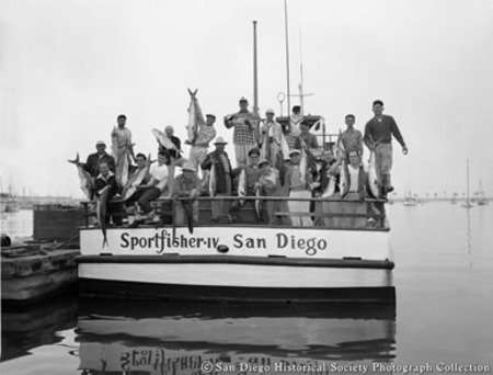 Group of fishermen posing with catch on board docked Sportfisher IV