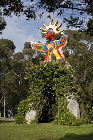 Sun God: general view of sculpture and arch with vines and eucalyptus grove in background