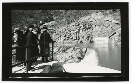People surveying Lake Hodges spillway from dam