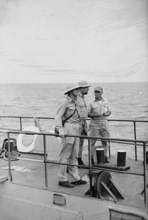 Martin W. (Martin Wiggo) Johnson, Norman J. Holter and Commander Hendrix on the landing craft near Bikini Island, during t...
