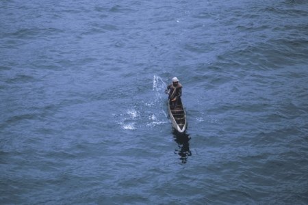 Greeted by native in dugout canoe [Freetown, Sierra Leone]
