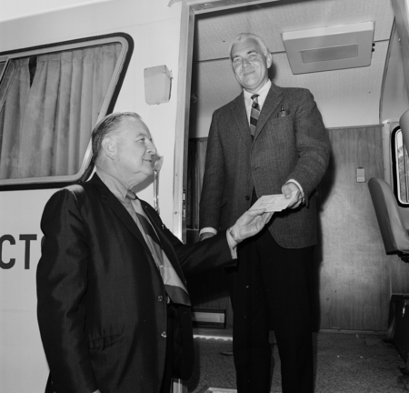 Chancellor William J. McGill (standing in mobile unit) receiving a donation check from Sears, Roebuck and Company represen...