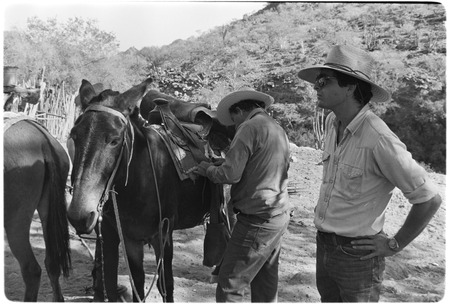 Ranchers inspecting saddle at Rancho San Martín