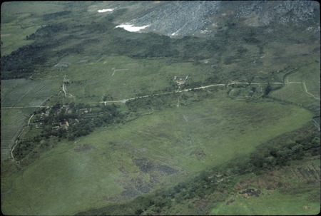 Balim Valley, aerial view of gardens and setlement, snow in background