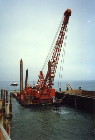Equipment on floating platforms during the construction of Ellen Browning Scripps Memorial Pier