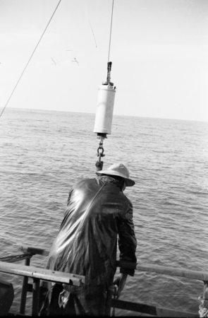 Crewmember collecting samples at sea aboard R/V E.W. Scripps