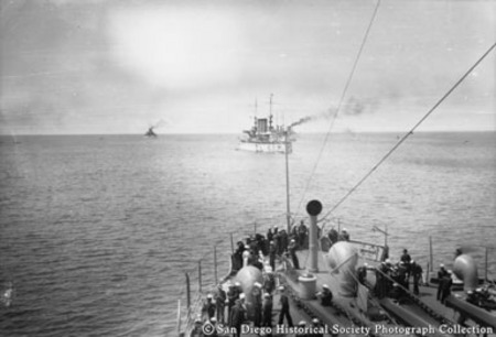 Sailors on deck of Great White Fleet flagship USS Connecticut looking astern at battleships