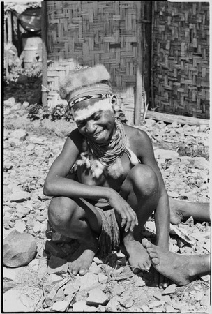 Adolescent girl, Kanila, with talcum powdered forehead, marsupial cap and other finery