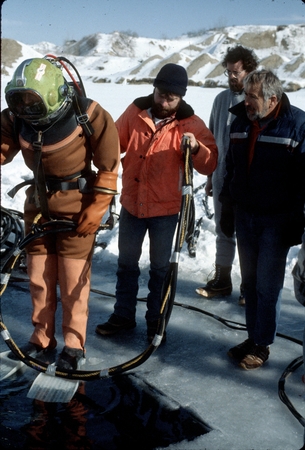 Helmet diving under the ice in Antarctica, likely at McMurdo Station. James Stewart at right