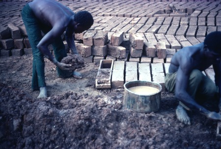 Men making mud bricks for a self-help community center in Kaputa village